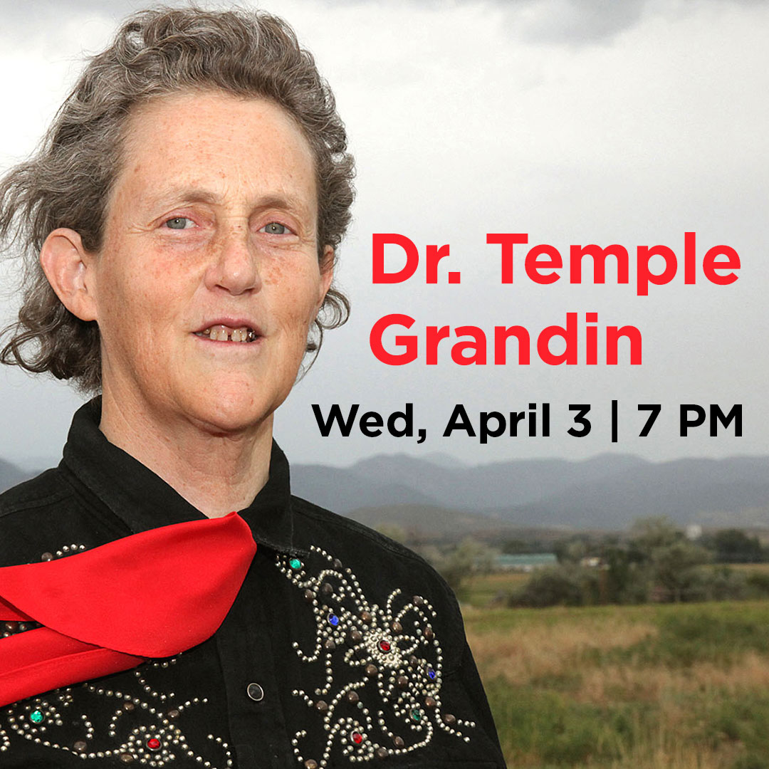 Photo of Dr. Temple Grandin in front of farmland