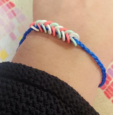 Blue bracelet with braided beads in pastel colors